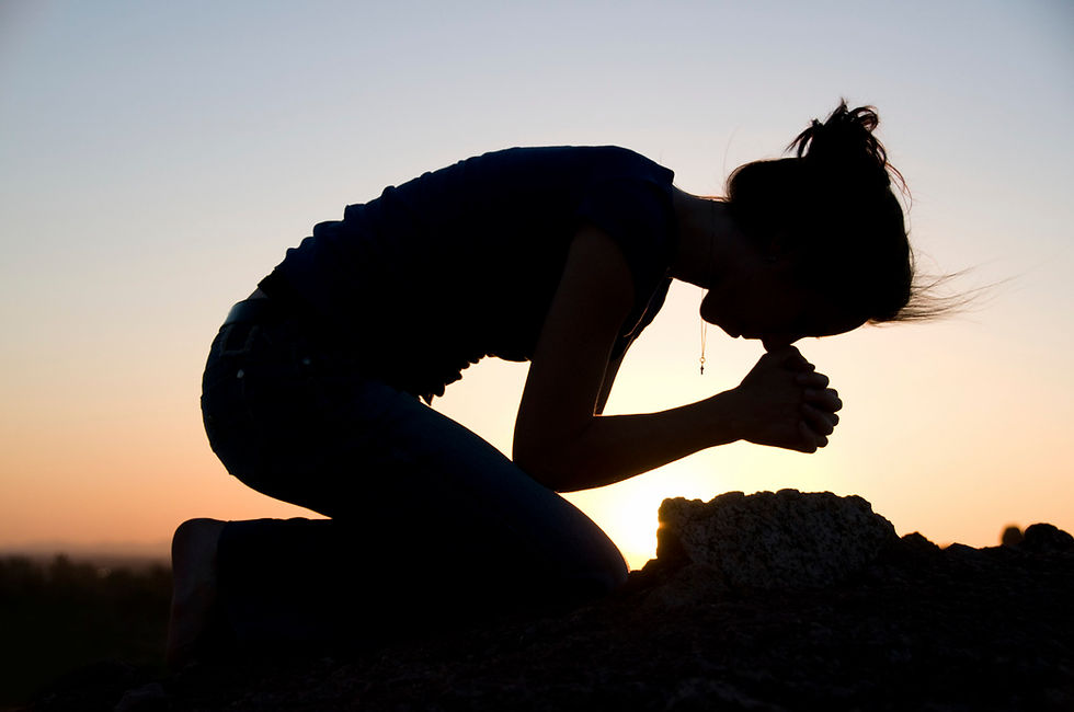 Woman praying on her knees.