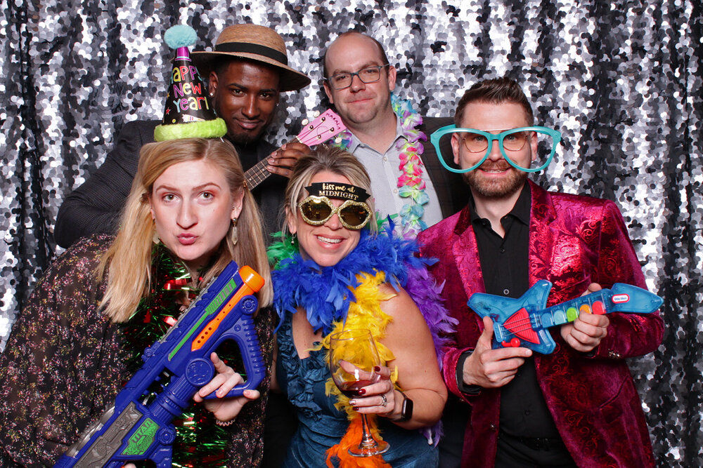 People with silver backdrop and props.
