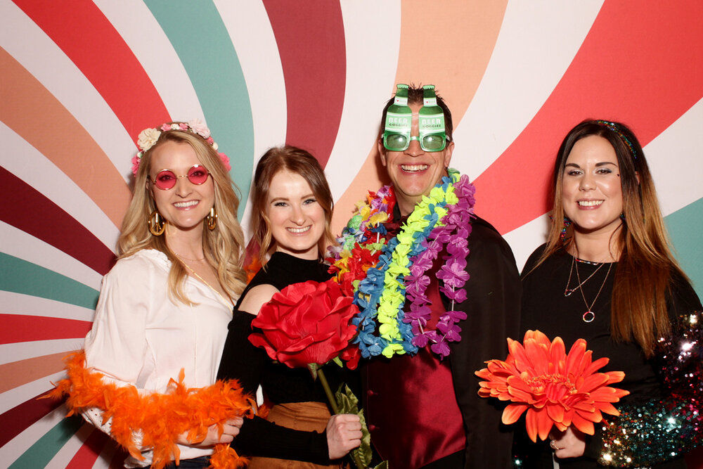 People with colorful backdrop and props.