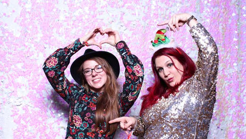 Ladies in front of unicorn backdrop