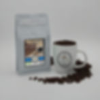 Thumbnail: Bag of Southern Bourbon Pecan coffee beans and mug with scattered beans
