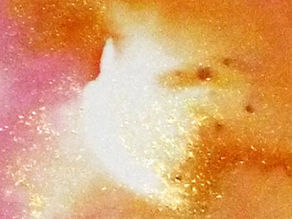 Abstract pink and orange nebula-like cloud with a bright white center and sparkling specks, dreamy cosmic background