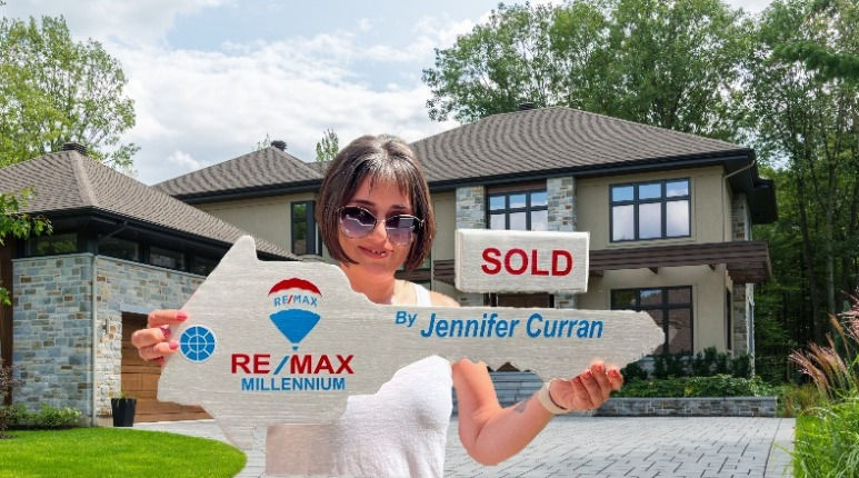 Thumbnail: Realtor key held by realtor in front of a new home