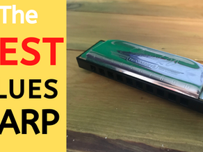 Photo of diatonic harmonica on wooden table. Title: THE BEST BLUES HARP