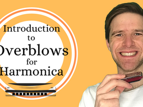 Man wearing white t-shirt, smiling and holding harmonica. Harmonica logo. Text: Introduction to Overblows for Harmonica
