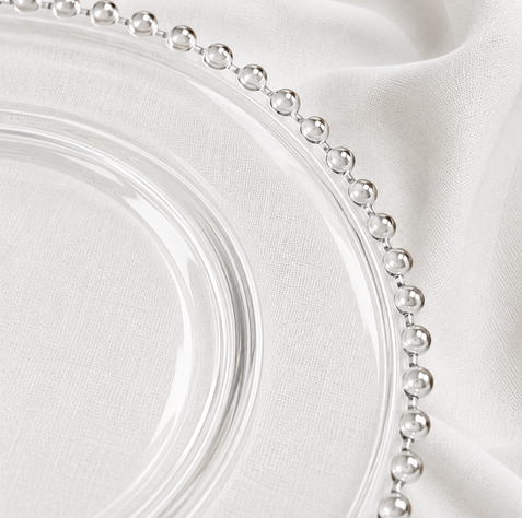 Close-up of clear charger plate with decorative beaded edge
