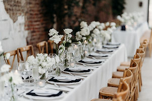 linear wedding table styling. ivory rose bud vases, porcelain chargers, silver cutlery and navy napkins
