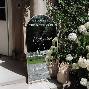 personalised wedding welcome gold mirror with basket of sun umbrellas
