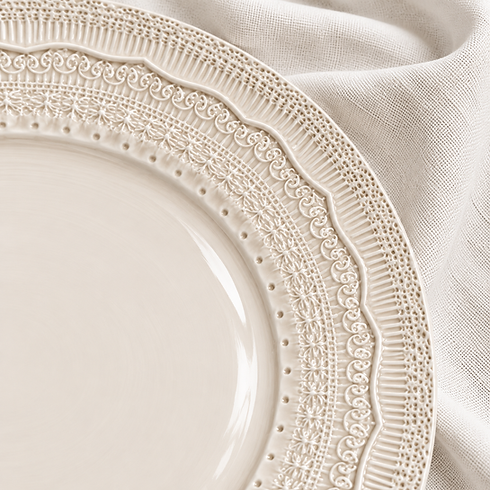 Close-up of Stone porcelain charger plate showing intricate embossed rim detailing