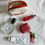 Thumbnail: Open canvas mini zip pouch showing perfume, lip tint, AirPods and hand cream.