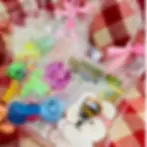 Cute kids party gift bags filled with mini toys, candy, and a bunny character sticker in a clear tote bag with pink gingham r