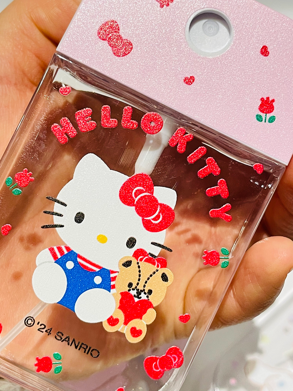 close-up of hello kitty spray bottle with fine mist
