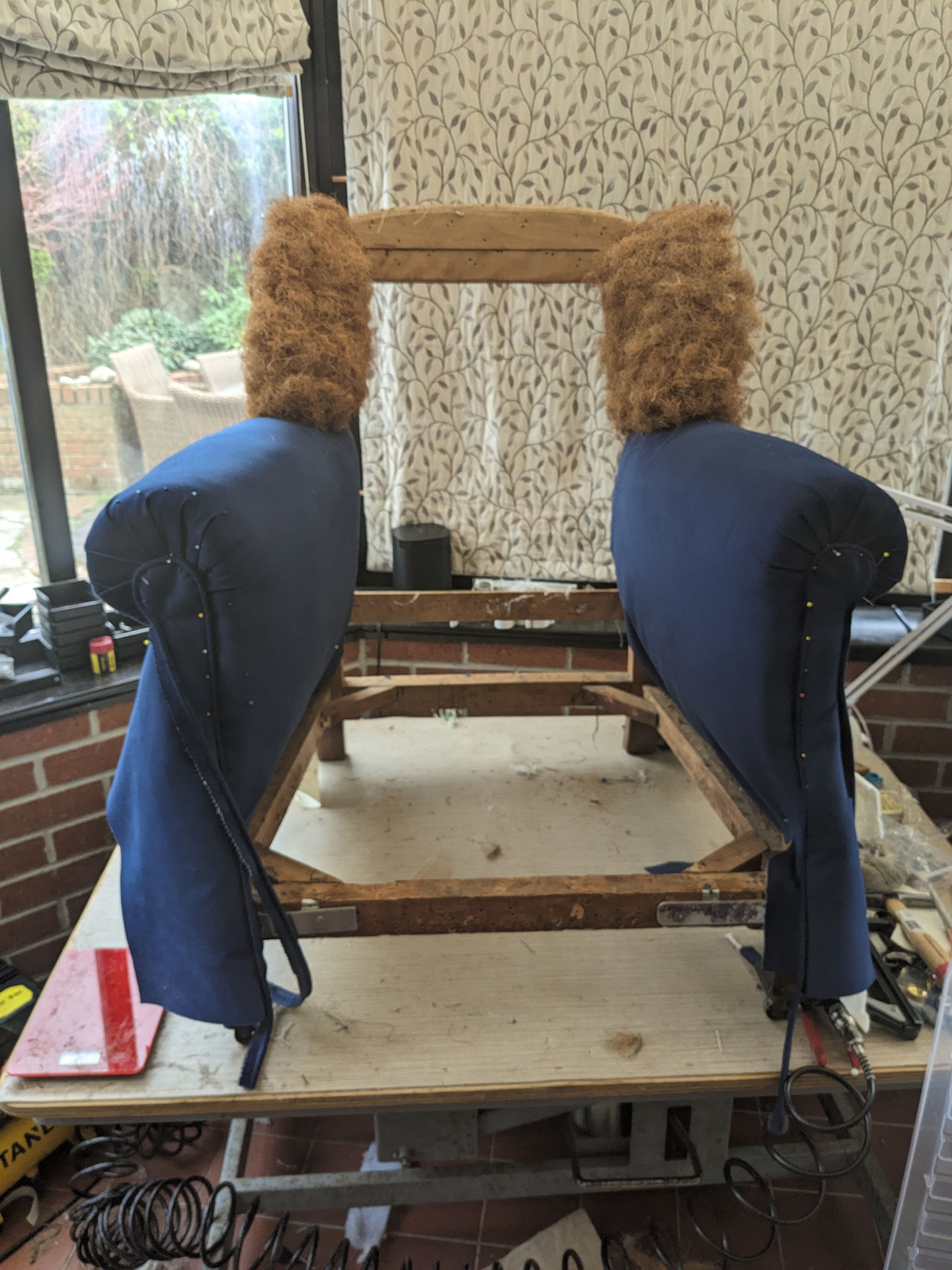 Traditional upholstery being used to restore antique armchair