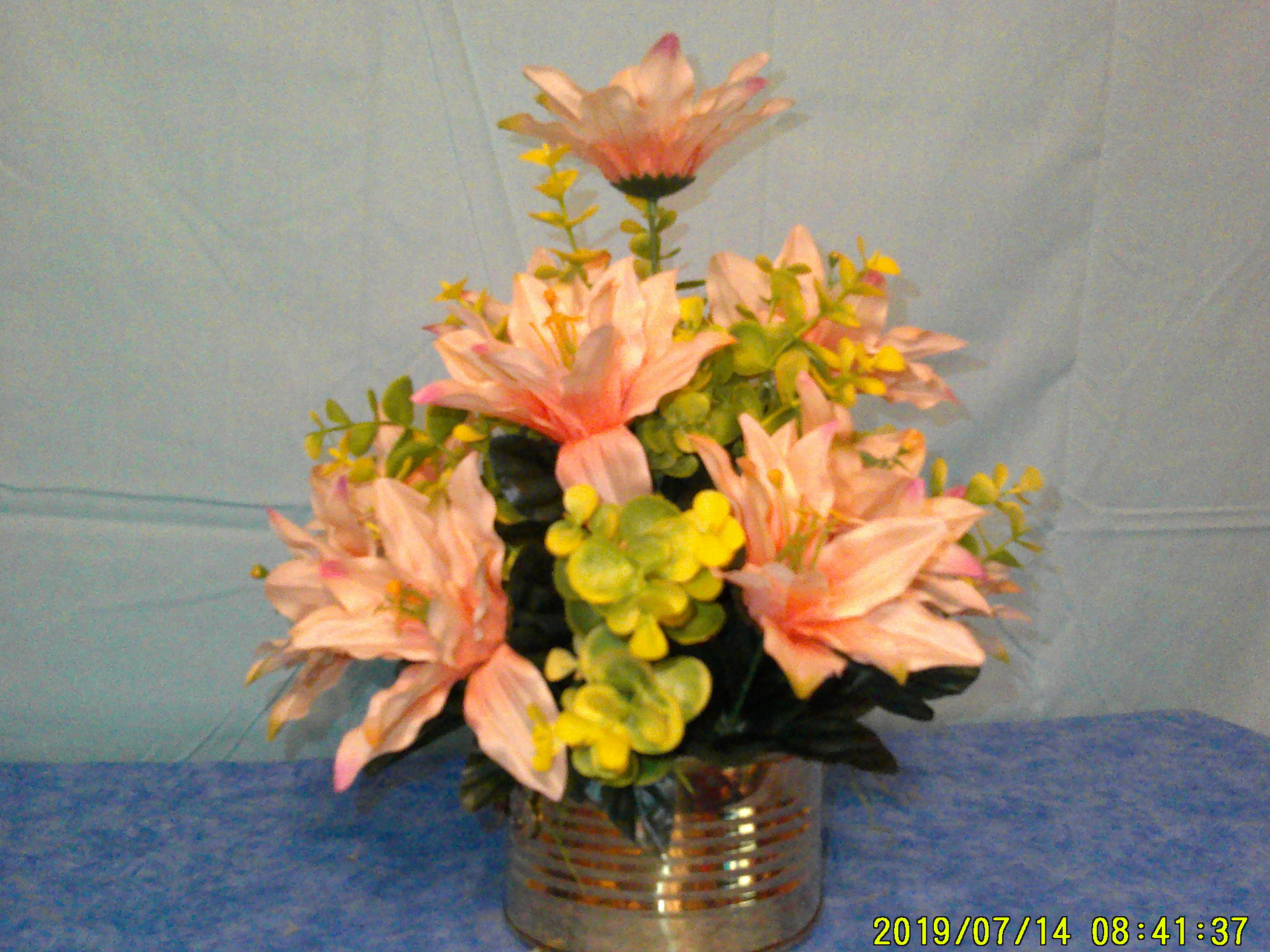 peach dahlia and eucalyptus in a brass