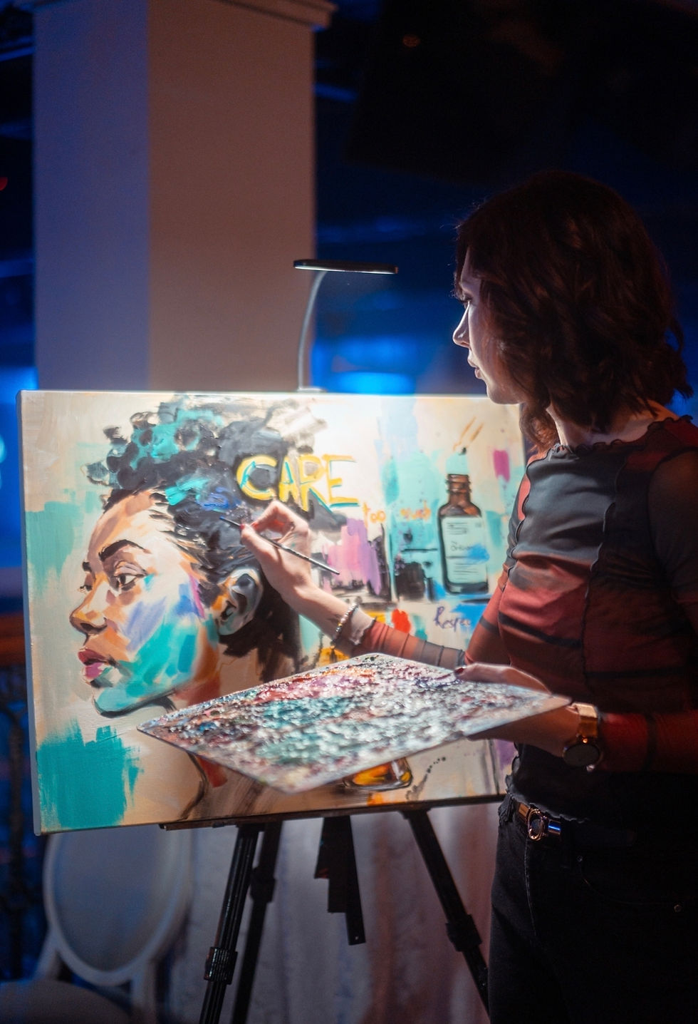 A vibrant canvas being painted live during a corporate event.
