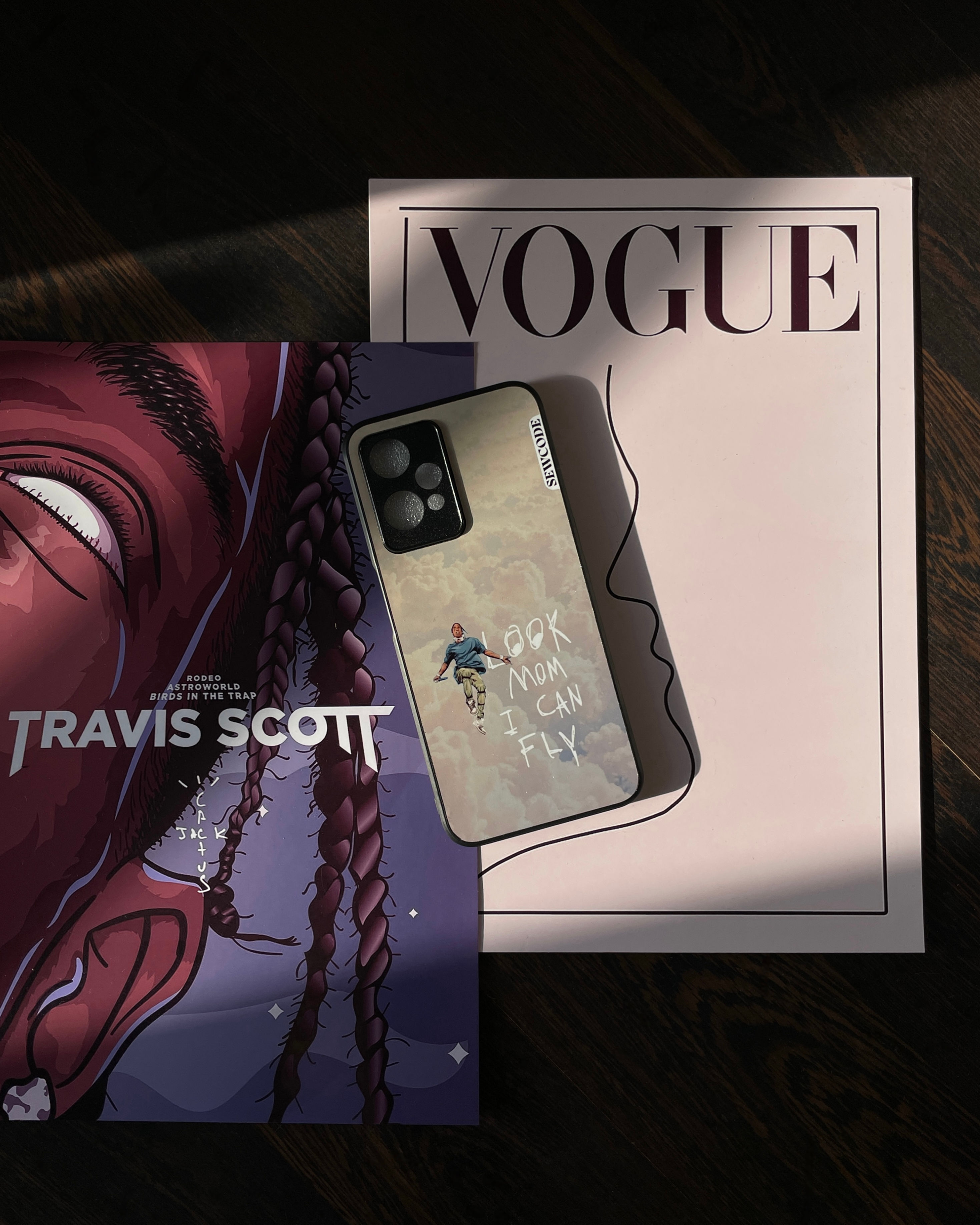 Phone case with a cloudy background, a small figure, and "LOOK MOM I CAN FLY" text.