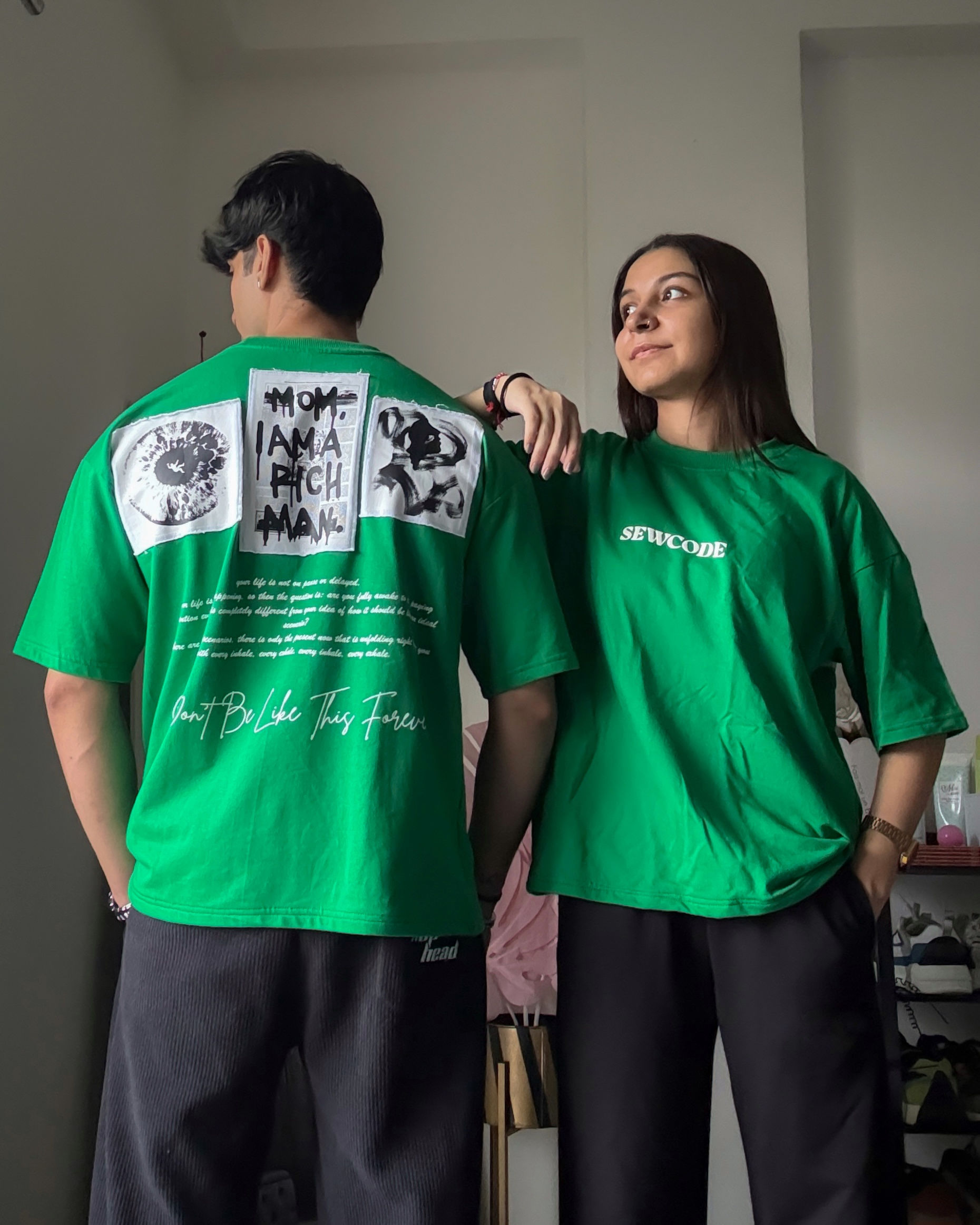 Unisex oversized green SEWCODE T-shirt with logo front and graphic back.