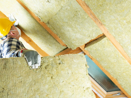 Man installing thermal roof insulation layer