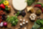 image of a table filled with ingredients needed to craft an Italian pizza