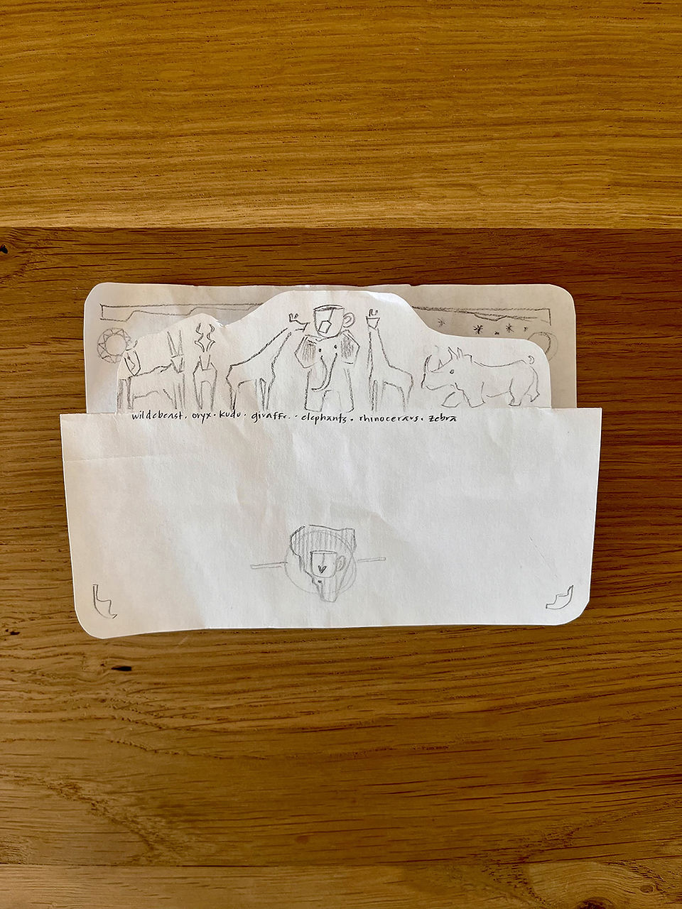 Close-up on first draft design of safari animal folded tea card design by Smarti.