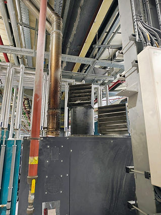 Specialist industrial machinery and complex piping setups inside a commercial manufacturing facility