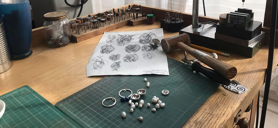 Jewellery on work bench with tools