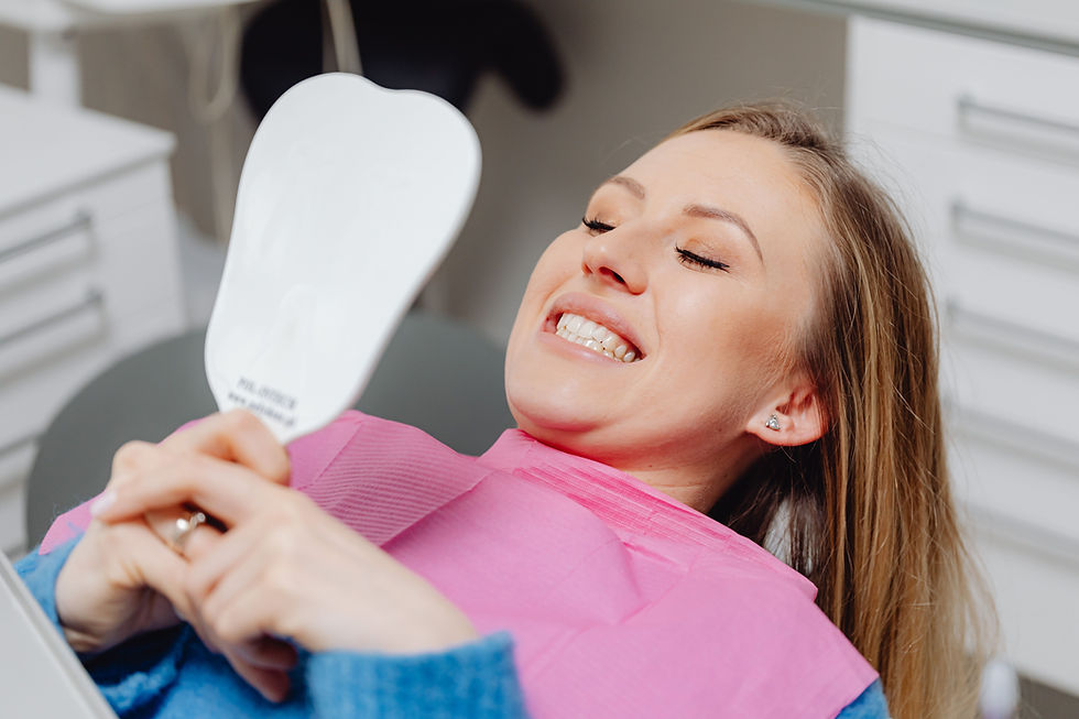 A woman smiling with a brighter smile after professional teeth whitening in Burlington and Oakville at Dental Edge.