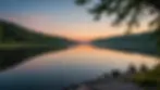 Eye-level view of a peaceful lake shore at dusk