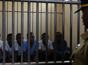 AI image of young men in detention under the watchful eye of a police officer the age of their father