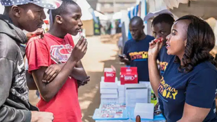 Woman health educator speaking to men about reproductive health