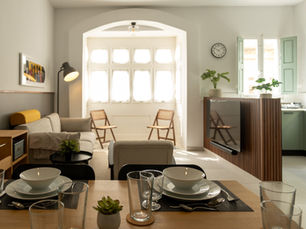 A full Morrison Court apartment in one view: living area, dining table and kitchen under arched windows