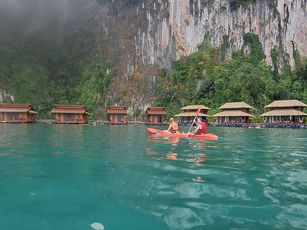 Guests swimming in the clear water beside Panvaree floating resort