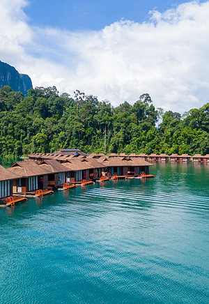 Floating raft houses at Laguna Chiew Larn surrounded by tropical rainforest scenery in Cheow Lan Lake