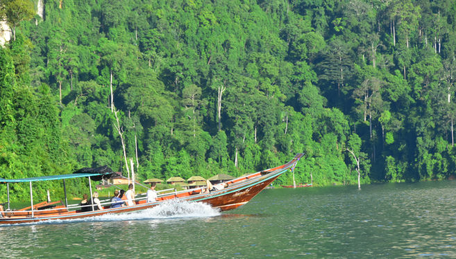 Traditional longtail boat cruising through Cheow Lan Lake