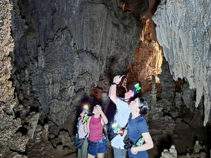 Guests exploring a cave near Cheow Lan Lake