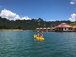 Guests kayaking near Saichon Rafthouse on Cheow Lan Lake in Khao Sok National Park