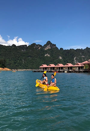 Guests kayaking near Saichon Rafthouse on Cheow Lan Lake in Khao Sok National Park