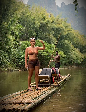 Travelers enjoying bamboo rafting through the rainforest river in Khao Sok National Park