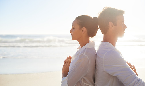 Couple Meditating on the Beach