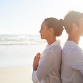 Couple Meditating on the Beach