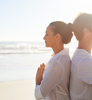 Couple Meditating on the Beach