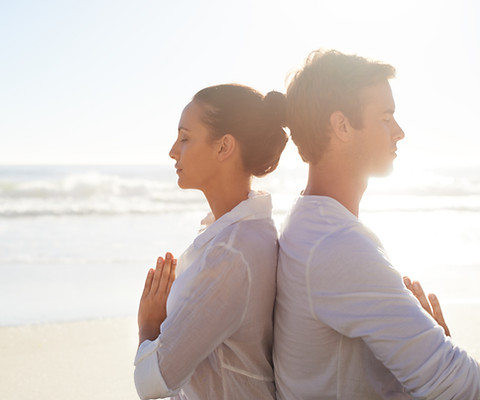 Couple Meditating on the Beach