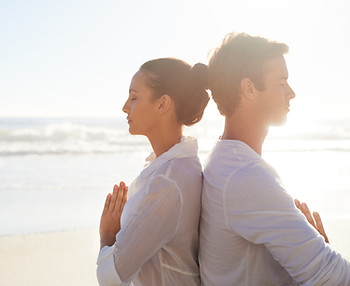 Couple Meditating on the Beach