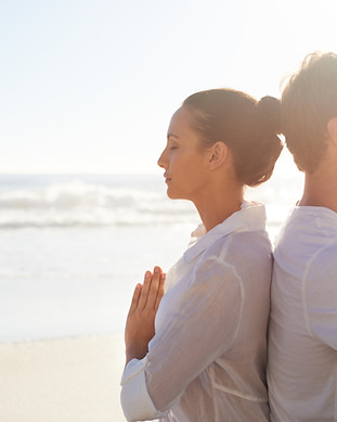 Couple Meditating on the Beach