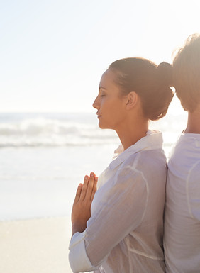 Couple Meditating on the Beach