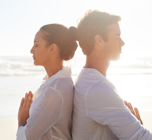 Couple Meditating on the Beach