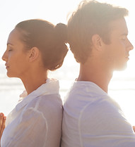 Couple Meditating on the Beach