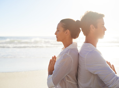 Couple Meditating on the Beach