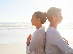 Couple Meditating on the Beach