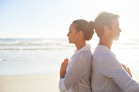 Couple Meditating on the Beach